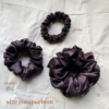 Fresh Brew scrunchie comparison in coffee brown, showcasing three sizes: petite, chunky, and XL. The petite scrunchie offers a more delicate, subtle look, the chunky scrunchie adds bold volume, and the XL scrunchie, four times the size of the chunky, provides maximum volume and impact. All scrunchies are made from smooth, luxurious charmeuse silk for a glossy, elegant finish.