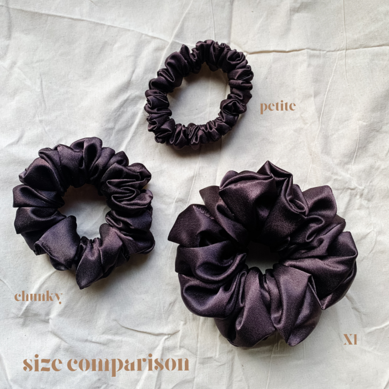 Fresh Brew scrunchie comparison in coffee brown, showcasing three sizes: petite, chunky, and XL. The petite scrunchie offers a more delicate, subtle look, the chunky scrunchie adds bold volume, and the XL scrunchie, four times the size of the chunky, provides maximum volume and impact. All scrunchies are made from smooth, luxurious charmeuse silk for a glossy, elegant finish.