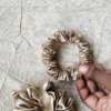 Rosé Glow metallic mauve scrunchie made from luxe charmeuse satin. Oversized design, approximately twice the size of a standard scrunchie, with a smooth, glossy finish that adds a touch of elegance to any hairstyle.