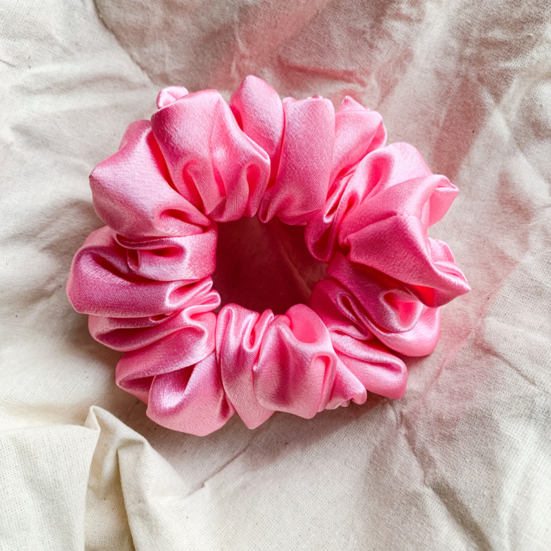 Pinkberry light pink chunky scrunchie made from luxe charmeuse satin. Oversized design, approximately twice the size of a standard scrunchie, with a smooth, glossy finish that adds a touch of elegance and volume to any hairstyle.