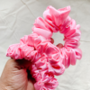 Pinkberry light pink chunky scrunchie made from luxe charmeuse satin. Oversized design, approximately twice the size of a standard scrunchie, with a smooth, glossy finish that adds a touch of elegance and volume to any hairstyle.