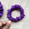 Amethyst royal purple petite scrunchie made from luxe charmeuse satin. Oversized design, approximately twice the size of a standard scrunchie, with a smooth, glossy finish that adds a touch of elegance to any hairstyle.