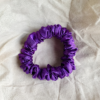 Amethyst royal purple petite scrunchie made from luxe charmeuse satin. Oversized design, approximately twice the size of a standard scrunchie, with a smooth, glossy finish that adds a touch of elegance to any hairstyle.