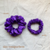 Amethyst Scrunchie comparison in royal purple, showcasing two sizes: petite, chunky. The petite scrunchie offers a more delicate, subtle look, the chunky scrunchie adds bold volume. All scrunchies are made from smooth, luxurious charmeuse silk for a glossy, elegant finish.