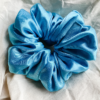 Blue Spark XL scrunchie in electric blue, made from luxurious charmeuse silk. Four times the size of the chunky scrunchie, this oversized scrunchie offers an extravagant, voluminous look with a smooth, glossy finish, perfect for making a bold statement or securing hair comfortably.