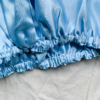 Blueberry reversible silk bonnet in baby blue. Made from smooth charmeuse silk, this bonnet features a comfortable elastic band for a secure fit, offering a soft, luxurious touch for protecting hair while sleeping or resting