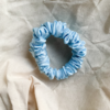 Blueberry baby blue scrunchie made from luxe charmeuse satin. Oversized design, approximately twice the size of a standard scrunchie, with a smooth, glossy finish that adds a touch of elegance to any hairstyle.