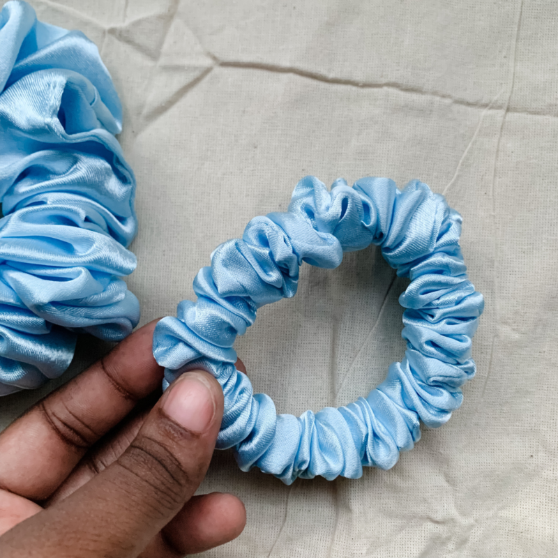 Blueberry baby blue scrunchie made from luxe charmeuse satin. Oversized design, approximately twice the size of a standard scrunchie, with a smooth, glossy finish that adds a touch of elegance to any hairstyle.