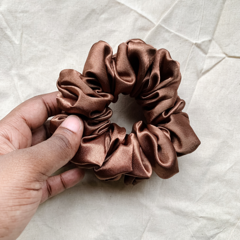 Cocoa Dream cocoa brown chunky scrunchie made from luxe charmeuse satin. Oversized design, approximately twice the size of a standard scrunchie, with a smooth, glossy finish that adds a touch of elegance and volume to any hairstyle.