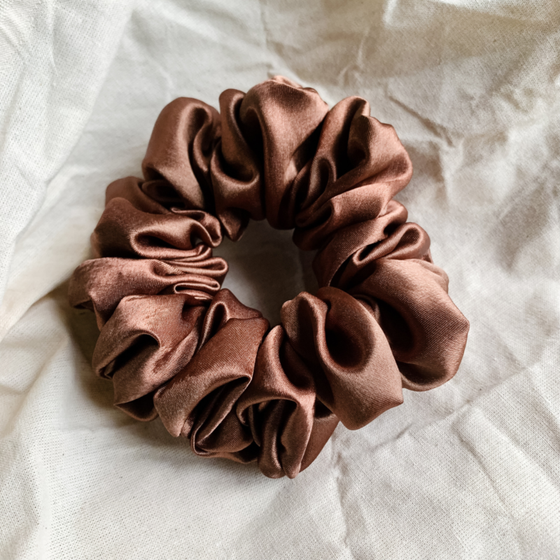 Cocoa Dream cocoa brown chunky scrunchie made from luxe charmeuse satin. Oversized design, approximately twice the size of a standard scrunchie, with a smooth, glossy finish that adds a touch of elegance and volume to any hairstyle.