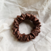 Coco Dream cocoa brown petite scrunchie made from luxe charmeuse satin. Oversized design, approximately twice the size of a standard scrunchie, with a smooth, glossy finish that adds a touch of elegance to any hairstyle.