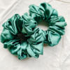 Evergreen Noel christmas green chunky scrunchie made from luxe charmeuse satin. Oversized design, approximately twice the size of a standard scrunchie, with a smooth, glossy finish that adds a touch of elegance and volume to any hairstyle.