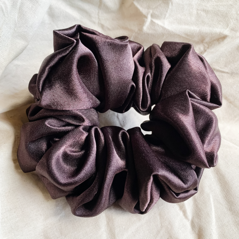 Fresh brew, coffee brown chunky scrunchie made from luxe charmeuse satin. Oversized design, approximately twice the size of a standard scrunchie, with a smooth, glossy finish that adds a touch of elegance and volume to any hairstyle.