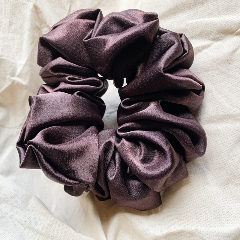 Fresh brew, coffee brown chunky scrunchie made from luxe charmeuse satin. Oversized design, approximately twice the size of a standard scrunchie, with a smooth, glossy finish that adds a touch of elegance and volume to any hairstyle.