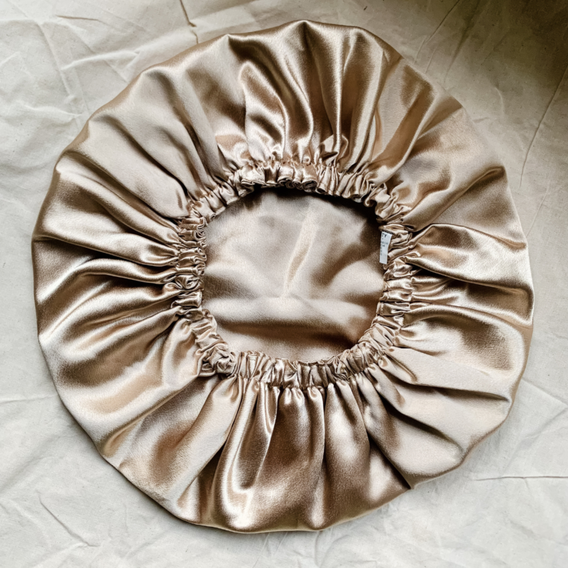 Golden Hour golden bonnet made from luxe charmeuse satin. Oversized design, approximately twice the size of a standard scrunchie, with a smooth, glossy finish that adds a touch of elegance to any hairstyle.