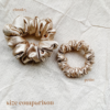 Golden Hour Scrunchie comparison in golden, showcasing two sizes: petite, chunky. The petite scrunchie offers a more delicate, subtle look, the chunky scrunchie adds bold volume. All scrunchies are made from smooth, luxurious charmeuse silk for a glossy, elegant finish.