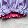 Lavender Blossom Silk Bonnet for Kids – Protects hair from frizz and moisture loss while sleeping. Made from soft charmeuse silk in lavender and rose pink, fits most children ages 2-6.