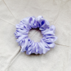 Lavender chunky scrunchie made from luxe charmeuse satin. Oversized design, approximately twice the size of a standard scrunchie, with a smooth, glossy finish that adds a touch of elegance and volume to any hairstyle.