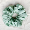 Matcha XL scrunchie in soft sage green, made from luxurious charmeuse silk. Four times the size of the chunky scrunchie, this oversized scrunchie offers an extravagant, voluminous look with a smooth, glossy finish, perfect for making a bold statement or securing hair comfortably.