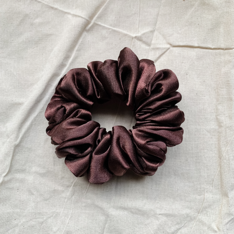 Melanin Magic deep brown chunky scrunchie made from luxe charmeuse satin. Oversized design, approximately twice the size of a standard scrunchie, with a smooth, glossy finish that adds a touch of elegance and volume to any hairstyle.