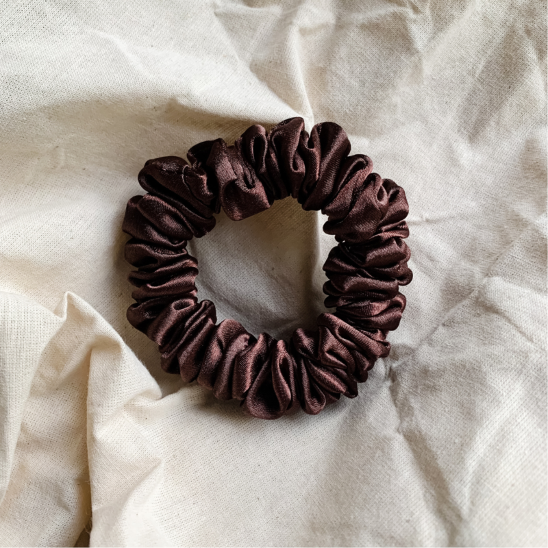 Melanin Magic deep brown scrunchie made from luxe charmeuse satin. Oversized design, approximately twice the size of a standard scrunchie, with a smooth, glossy finish that adds a touch of elegance to any hairstyle.