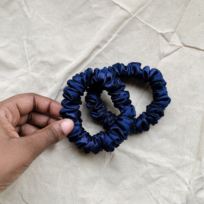 Midnight Tide navy blue petite scrunchie made from luxe charmeuse satin. Oversized design, approximately twice the size of a standard scrunchie, with a smooth, glossy finish that adds a touch of elegance to any hairstyle.