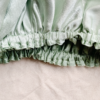 Minted Matcha Latte reversible silk bonnet in frosted mint green and sage green . Made from smooth charmeuse silk, this bonnet features a comfortable elastic band for a secure fit, offering a soft, luxurious touch for protecting hair while sleeping or resting