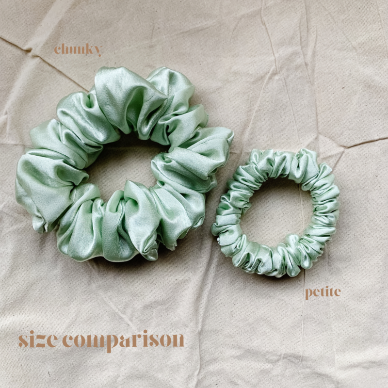 Minted Scrunchie comparison in dusty mint green, showcasing two sizes: petite, chunky. The petite scrunchie offers a more delicate, subtle look, the chunky scrunchie adds bold volume. All scrunchies are made from smooth, luxurious charmeuse silk for a glossy, elegant finish.