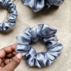 Moonlit Silver chunky scrunchie made from luxe charmeuse satin. Oversized design, approximately twice the size of a standard scrunchie, with a smooth, glossy finish that adds a touch of elegance and volume to any hairstyle.