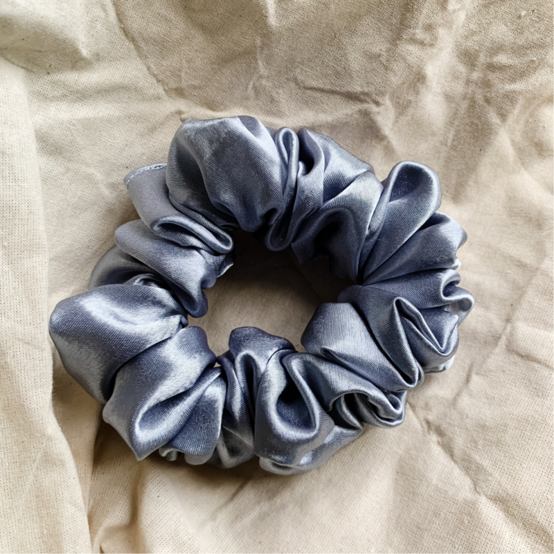 Moonlit Silver chunky scrunchie made from luxe charmeuse satin. Oversized design, approximately twice the size of a standard scrunchie, with a smooth, glossy finish that adds a touch of elegance and volume to any hairstyle.