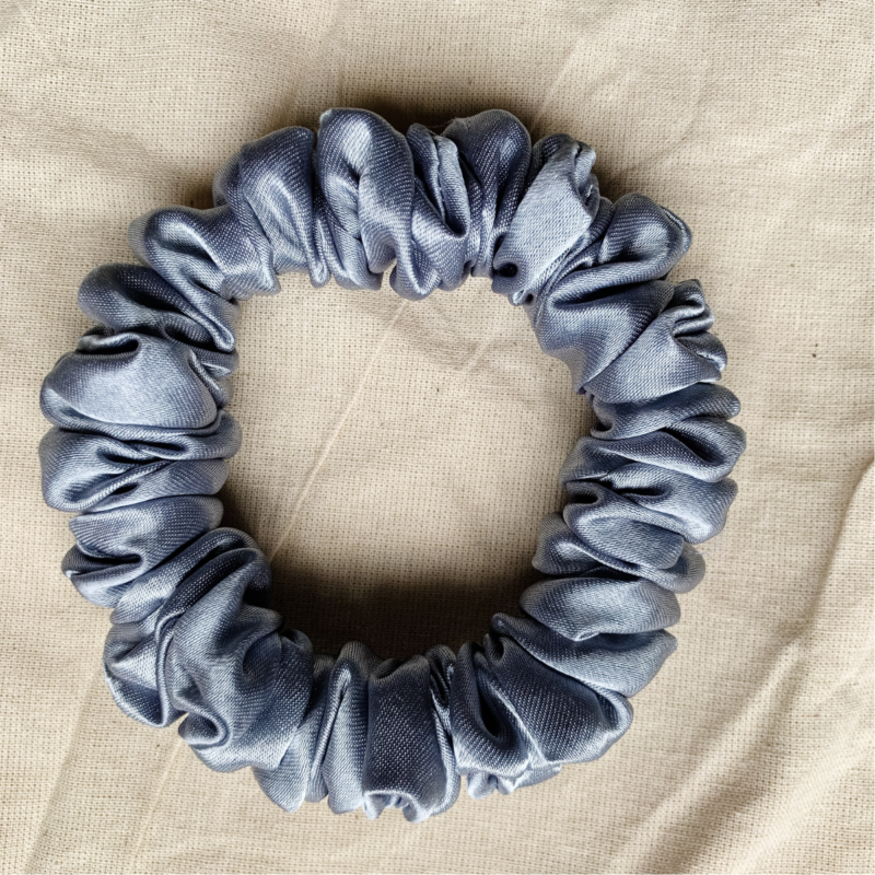 Moonlit Silver petite scrunchie made from luxe charmeuse satin. Oversized design, approximately twice the size of a standard scrunchie, with a smooth, glossy finish that adds a touch of elegance to any hairstyle.