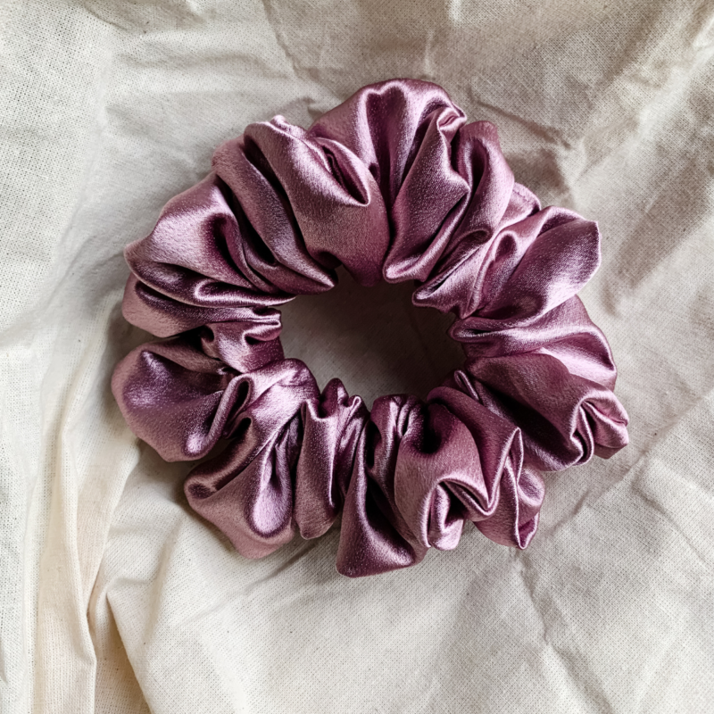 Rosé Glow metallic mauve chunky scrunchie made from luxe charmeuse satin. Oversized design, approximately twice the size of a standard scrunchie, with a smooth, glossy finish that adds a touch of elegance and volume to any hairstyle.