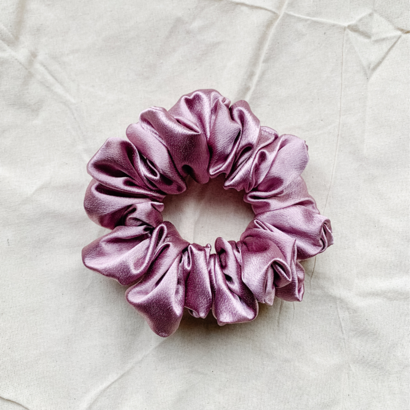 Rosé Glow metallic mauve chunky scrunchie made from luxe charmeuse satin. Oversized design, approximately twice the size of a standard scrunchie, with a smooth, glossy finish that adds a touch of elegance and volume to any hairstyle.