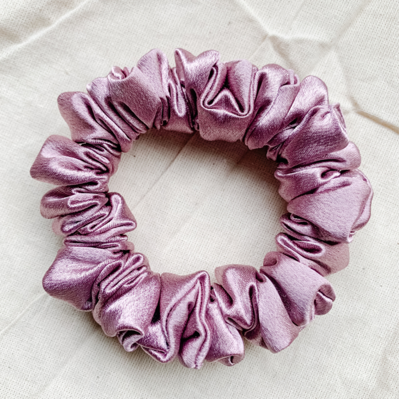 Rosé Glow metallic mauve scrunchie made from luxe charmeuse satin. Oversized design, approximately twice the size of a standard scrunchie, with a smooth, glossy finish that adds a touch of elegance to any hairstyle.