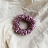 Rosé Glow metallic mauve scrunchie made from luxe charmeuse satin. Oversized design, approximately twice the size of a standard scrunchie, with a smooth, glossy finish that adds a touch of elegance to any hairstyle.