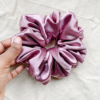 Rosé Glow XL scrunchie in metallic mauve, made from luxurious charmeuse silk. Four times the size of the chunky scrunchie, this oversized scrunchie offers an extravagant, voluminous look with a smooth, glossy finish, perfect for making a bold statement or securing hair comfortably.