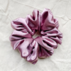 Rosé Glow XL scrunchie in metallic mauve, made from luxurious charmeuse silk. Four times the size of the chunky scrunchie, this oversized scrunchie offers an extravagant, voluminous look with a smooth, glossy finish, perfect for making a bold statement or securing hair comfortably.