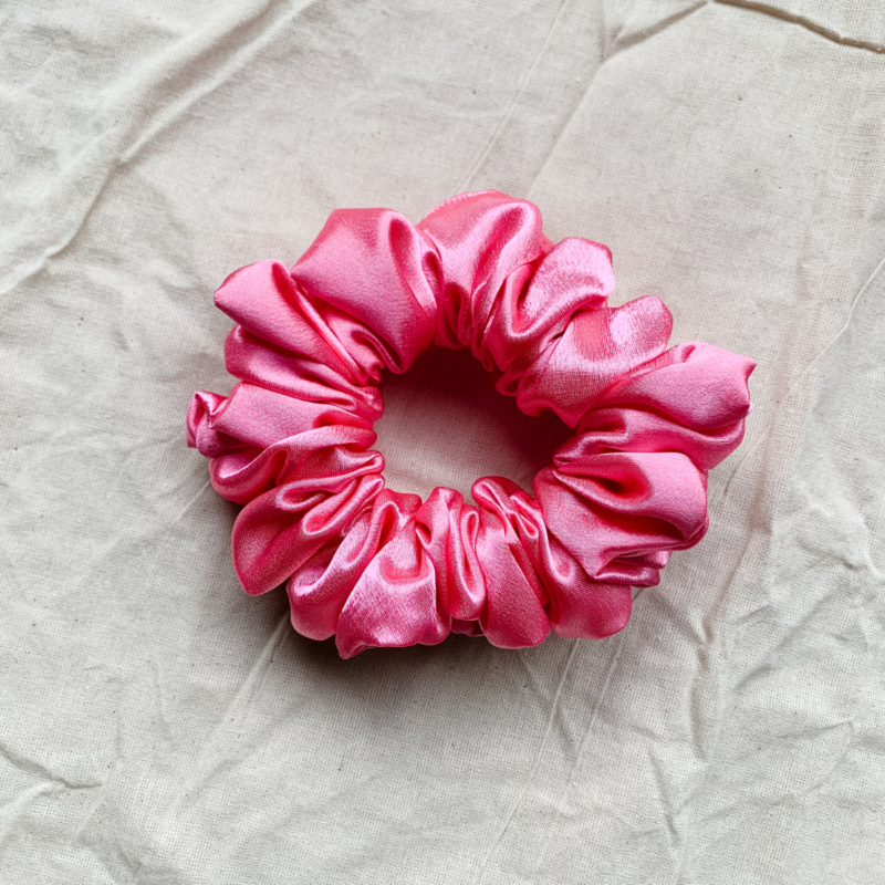 Rosette rose pink chunky scrunchie made from luxe charmeuse satin. Oversized design, approximately twice the size of a standard scrunchie, with a smooth, glossy finish that adds a touch of elegance and volume to any hairstyle.