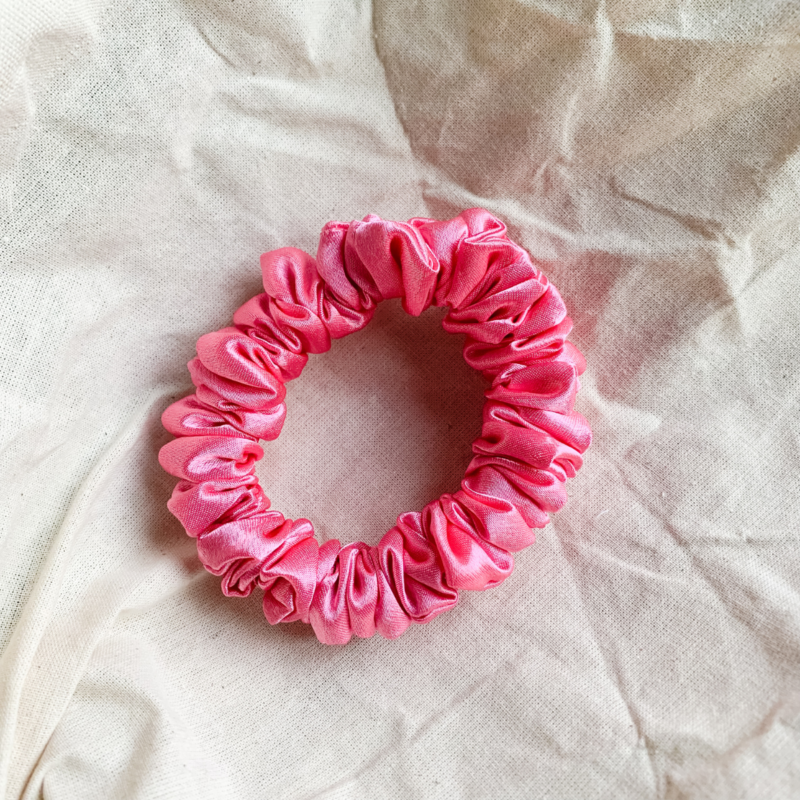 Rosette rose pink petite scrunchie made from luxe charmeuse satin. Oversized design, approximately twice the size of a standard scrunchie, with a smooth, glossy finish that adds a touch of elegance to any hairstyle.