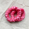 Rosette rose pink petite scrunchie made from luxe charmeuse satin. Oversized design, approximately twice the size of a standard scrunchie, with a smooth, glossy finish that adds a touch of elegance to any hairstyle.