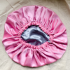 Silver Rose reversible silk bonnet in silver and light pink. Made from smooth charmeuse silk, this bonnet features a comfortable elastic band for a secure fit, offering a soft, luxurious touch for protecting hair while sleeping or resting.
