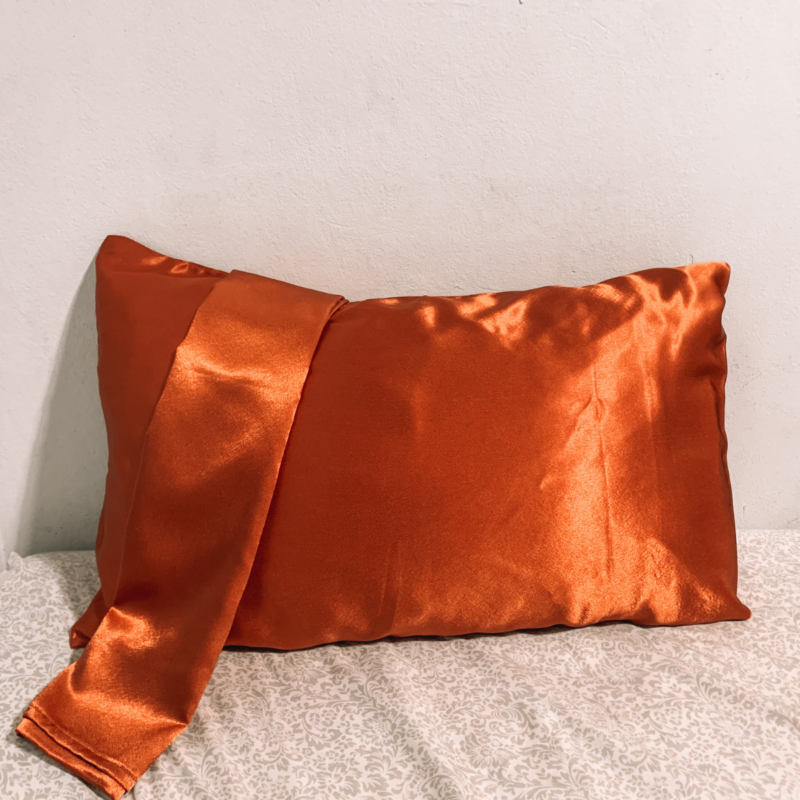 Sunset Glow Charmeuse Silk Pillowcase – Terracotta in color, made from 100% luxurious charmeuse silk, offering a smooth and soft texture for a restful night's sleep.