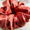Sunset Glow terracotta xl scrunchie made from luxe charmeuse satin. Oversized design, approximately twice the size of a standard scrunchie, with a smooth, glossy finish that adds a touch of elegance and volume to any hairstyle.