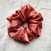 Sunset Glow terracotta xl scrunchie made from luxe charmeuse satin. Oversized design, approximately twice the size of a standard scrunchie, with a smooth, glossy finish that adds a touch of elegance and volume to any hairstyle.