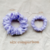 Lavender scrunchie comparison in soft lavender, showcasing two sizes: petite, chunky. The petite scrunchie offers a more delicate, subtle look, the chunky scrunchie adds bold volume. All scrunchies are made from smooth, luxurious charmeuse silk for a glossy, elegant finish.